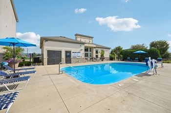 Sparkling swimming pool with sundeck & grill